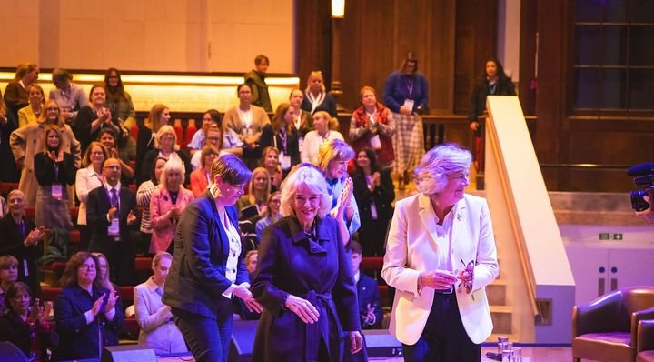 Her Majesty The Queen on stage as the summit audience stands to applaud